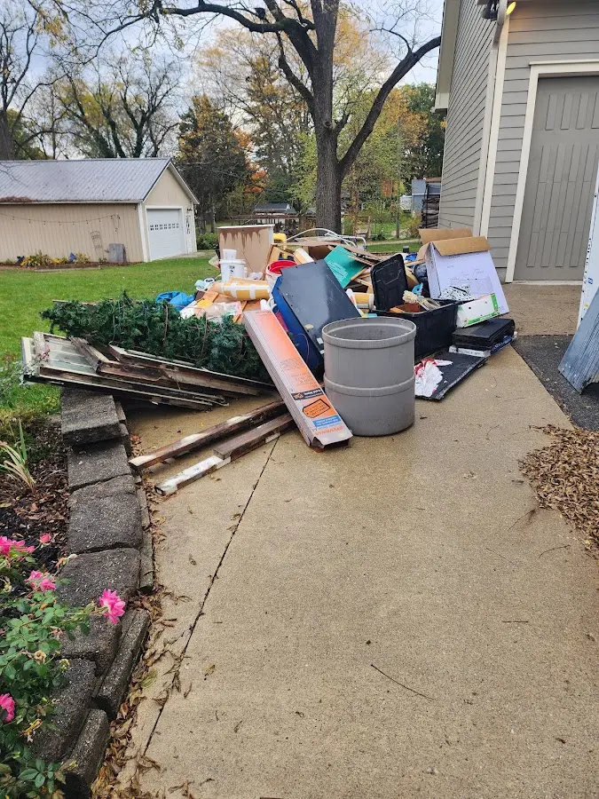 Dumpster being loaded with debris for 12 Yard Dumpster Rental in Cypress Gardens